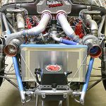 The Chevy's front suspension is more conventional than the swing arm, utilizing Lamb Pro Stock struts. In this photo the coil springs have been taken off to test the suspension's travel and measure how much clearance there is between the front tires and the twin turbochargers when the struts are at full compression.