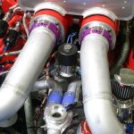 Banks’ engineers are also experimenting with a single, central nitrous solenoid split to two nozzles. This would be a simpler system, but would require longer lines between the solenoid and the nozzles than the setup shown above. The single solenoid system was mounted to the demonstration engine seen when the truck was displayed at the SEMA Show.