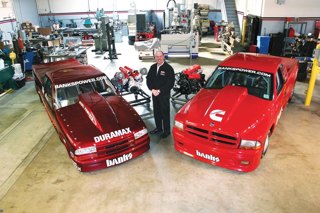 Gale Banks with two key vehicles important to the company history.