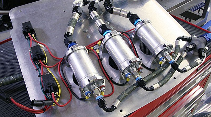 Leno6-plumb1_lg Three pumps, no waiting! On the wet side of the EFI system, Bosch provided us with their 200 liter-per-hour, 5-bar (72 psig) electric fuel pumps. With each pump putting out just under one gallon per minute, it'll take three of them in parallel to feed this monster. We mounted the pumps and relays on one side of a vertical panel with twin inlet filters on the other. All of the hose assemblies were made using XRP's HS-79 smooth-bore Teflon/Kevlar hose and crimp-on hose ends.