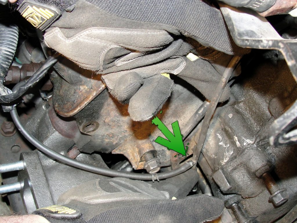 The return fuel line to the injector pump is located on the front side of the right cylinder head. This line must be carefully bent and re-routed to keep it as far away as possible from the new exhaust manifold. As you can see, we removed the right-hand alternator to gain more access to the line.