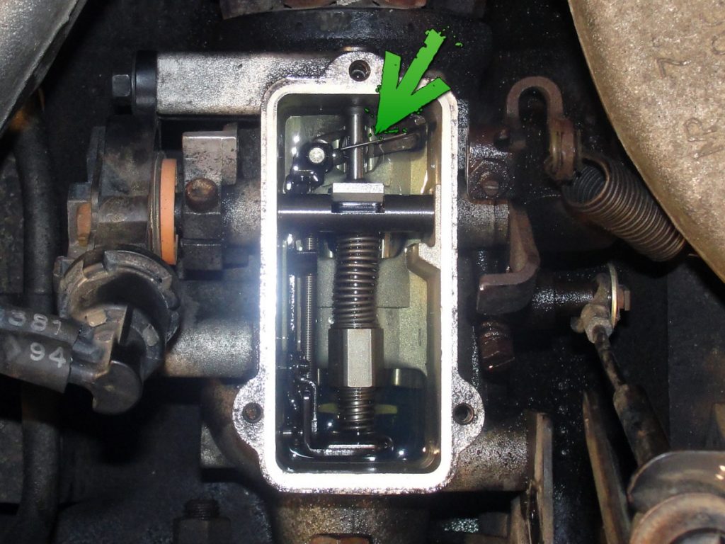 To access the adjustment screw, the pump cover is removed. To make things easier, we ended up siphoning some of the diesel from the pump bowl. The governor spring assembly is then removed by removing the guide stud and sealing washer located at the rear of the pump. After removing the spring assembly, the adjustment slot is clearly visible. If you cannot see the adjustment screw in the slot, the engine must be rotated by hand to bring the Allen screw into view. Once visible, use a 5/32” Allen wrench to rotate the screw 1/4″ turn clockwise. The screw turns tight so be sure you have a good bite before making the adjustment.