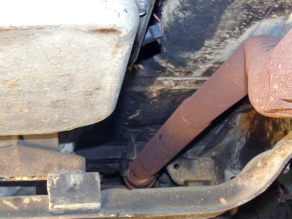 The exhaust can now be removed. You must retain one exhaust to manifold flange and hardware for re-use as well as one doughnut gasket. In our case both doughnut gaskets were pretty much shot, so we picked up a new one anyway. (ref: rusty underneath pipe)