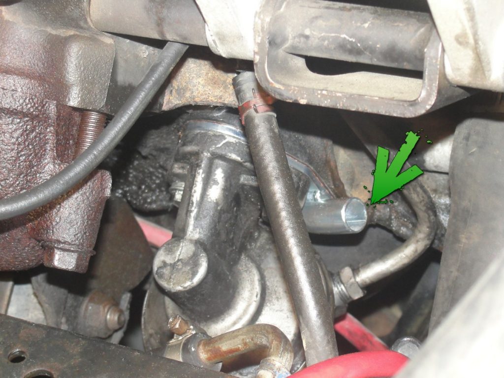 The fuel lines are then disconnected at the lift pump. The lift pump and factory spacer plate are removed. The fuel pump rod will want to slip out, but a good coating of grease will help keep it in place while the mounting surface is cleaned and a new spacer plate is installed before re-attaching the lift pump. The new spacer plate contains a tube used for the return of oil from the turbo.