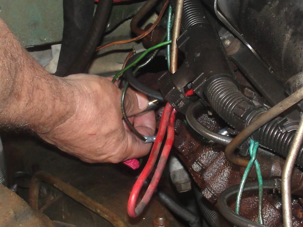 The right side glow plugs are then removed as well as the factory exhaust manifold. Twenty-six years can create one incredible bond as the studs were not the easiest to remove. To gain greater access the batteries and battery trays were removed. Despite the additional clearance one exhaust manifold bolt still had to be cut. After removing the factory manifold, a bolt was welded to what was left of the stud and the bolt was removed.