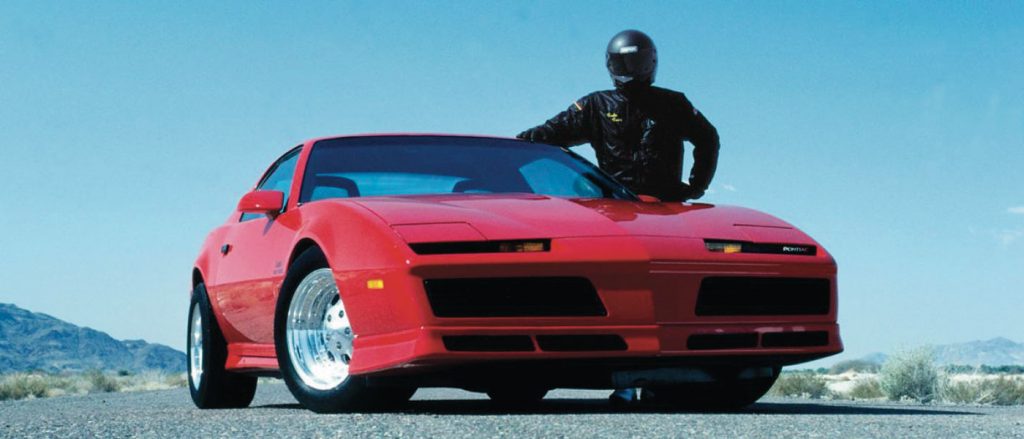 Gale standing next to a Firebird that helped build the tuner car craze.