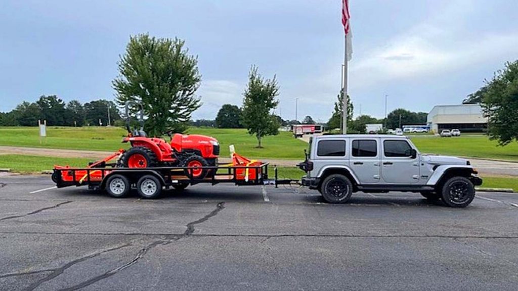 The EcoDiesel with a trailor loaded with a lawnmower.
