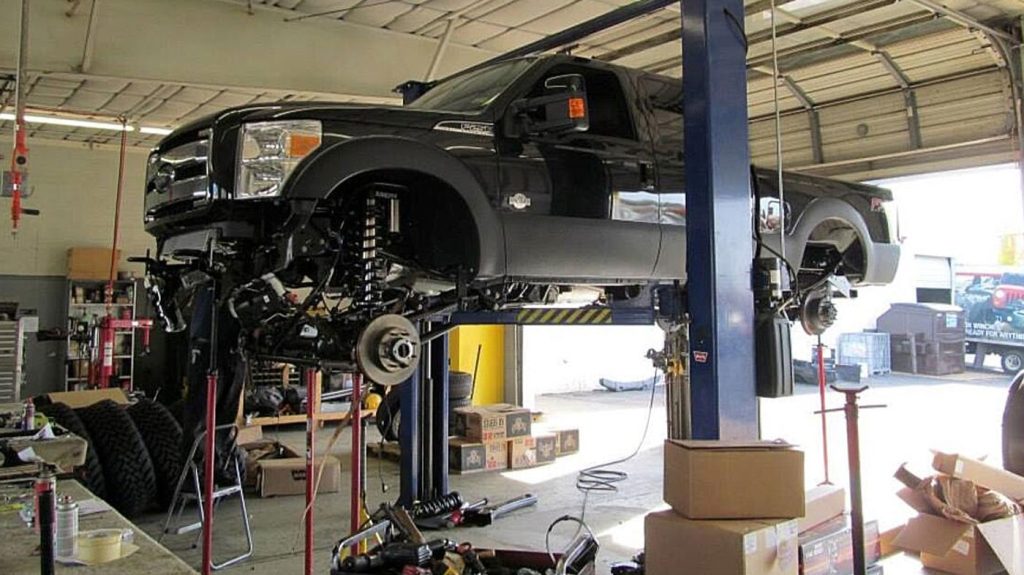 A truck up on the lift at Woody's Accessories & Off-Road