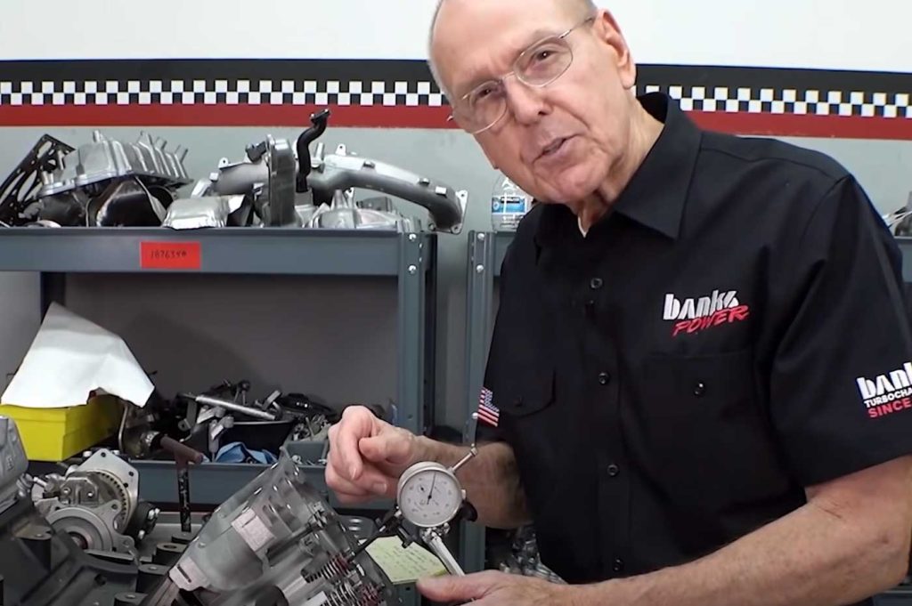 Gale measures the valve-to-piston clearance to prepare for the new camshaft.