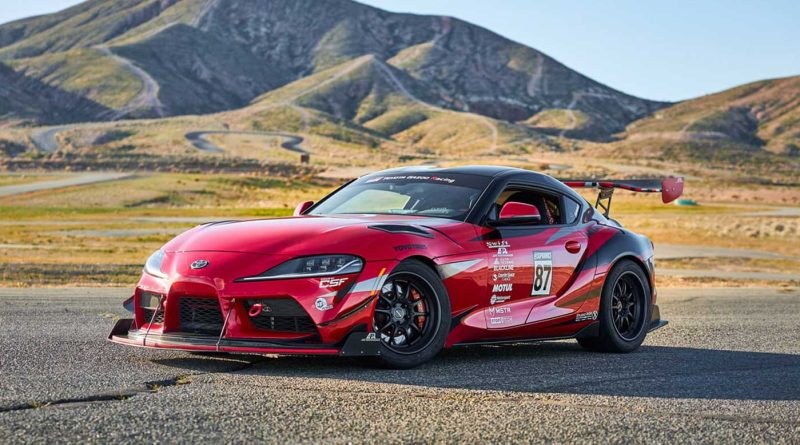 Toyota Supra parked on track, in front of mountains