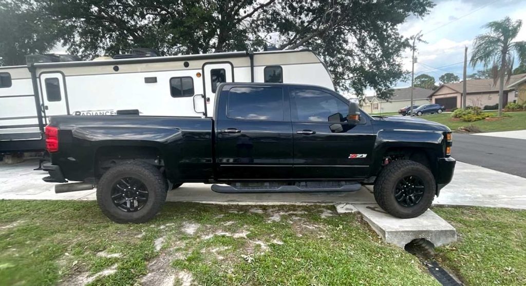 A side view of the truck and trailer owned by Patrick