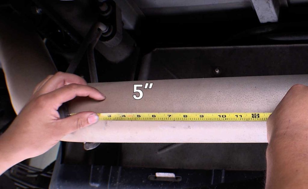 Measure five inches from the exhaust hanger to the diesel particulate filter. With a marker, mark a visual of where to cut.