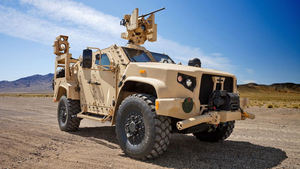 JLTV parked in a desert landscape with gun at the ready. 