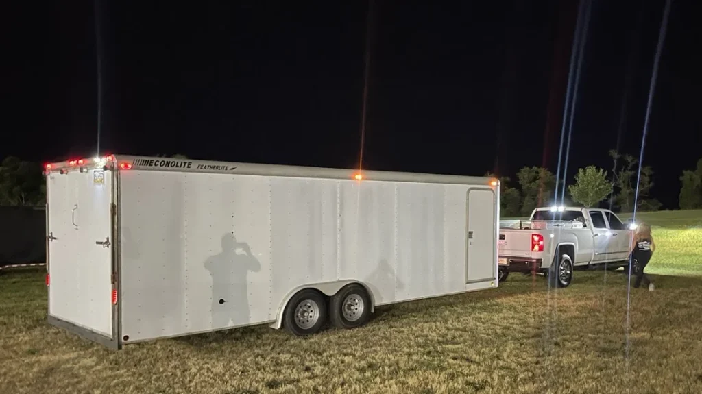 Vincent's GMC Sierra towing a race trailer or heavy equipment.