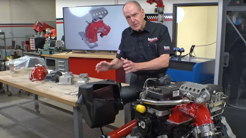 A Banks Monster-Ram intake elbow next to a stock RAM intake elbow, highlighting the size difference.