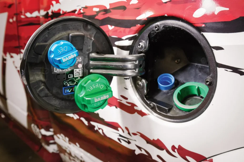 Close-up of Banks billet fuel and DEF caps installed on a RAM truck.