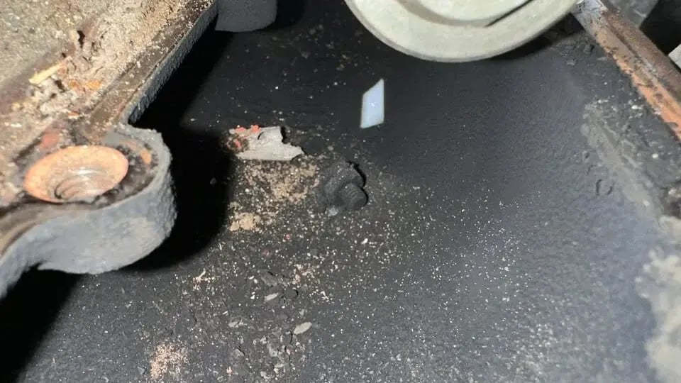 Loose factory grid heater nut and melted post resting inside the carbon-coated intake manifold of Hector's 2015 RAM 3500 Cummins